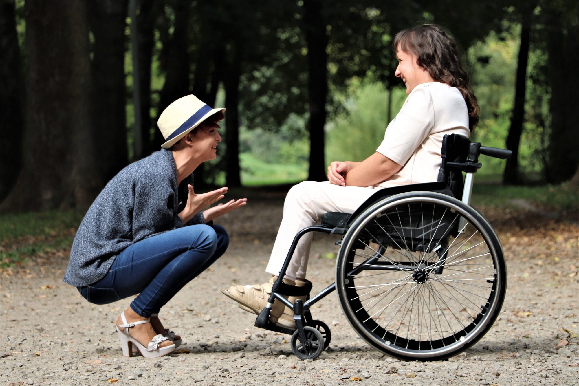 a woman on the wheelchair receiving support from a carer