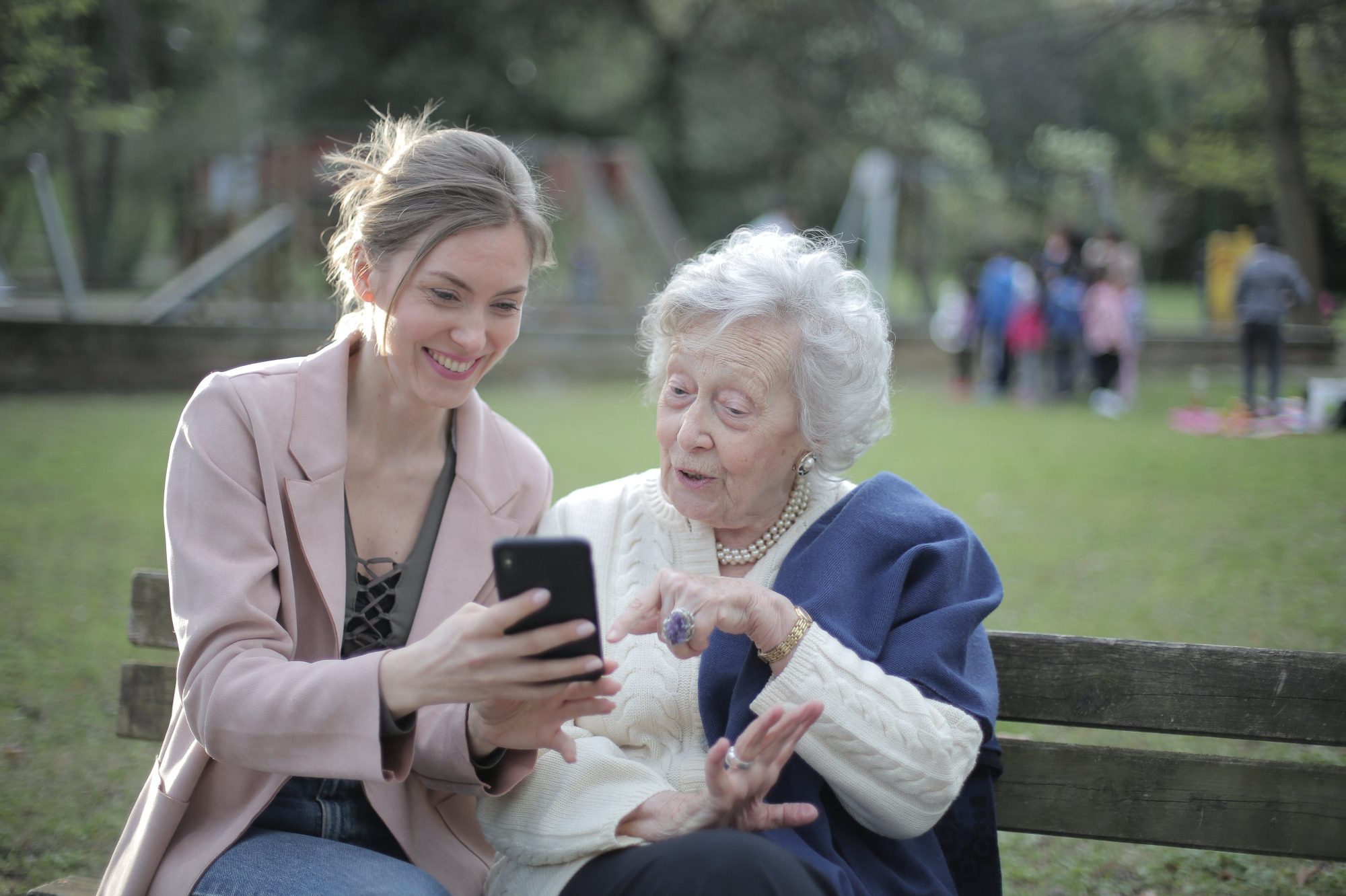 social worker helping an elderly person with her mobile phone 