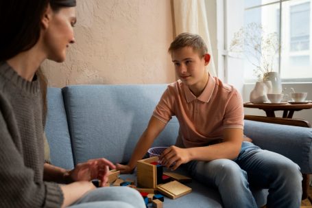 Boy sitting on the couch with his social worker